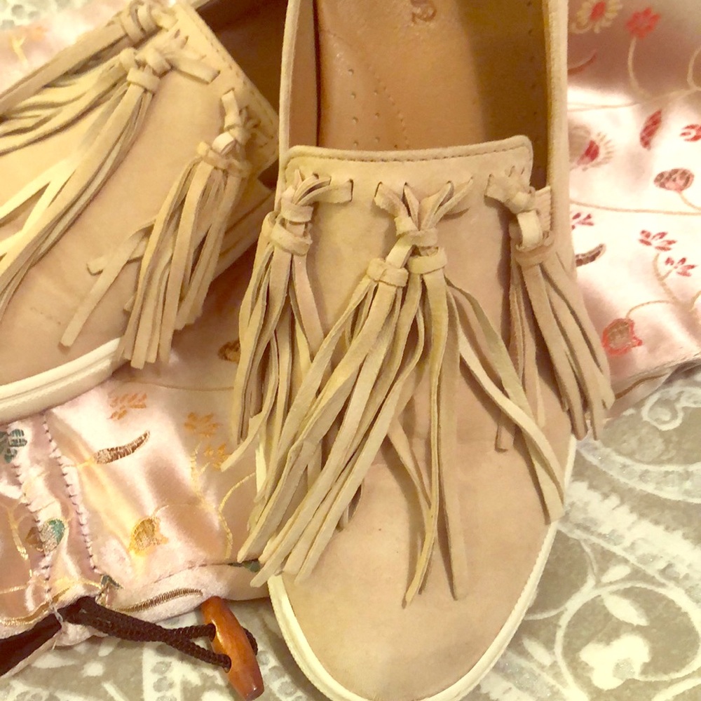 Light pink suede sneaker with long suede tassels.